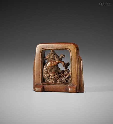 A WOOD NETSUKE OF A TSUITATE (STANDING SCREEN) WITH A SHISHI...