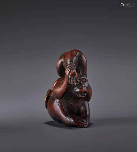 A FINE WOOD NETSUKE OF TWO MONKEYS AND PEACH SIGNED MASATSUG...