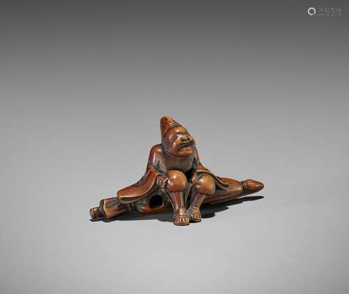 A WOOD NETSUKE OF A TEMPLE SERVANT (EJI)