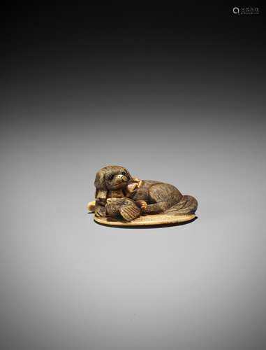 Ɏ A STAINED IVORY NETSUKE OF A PUPPY AND A SPARROW