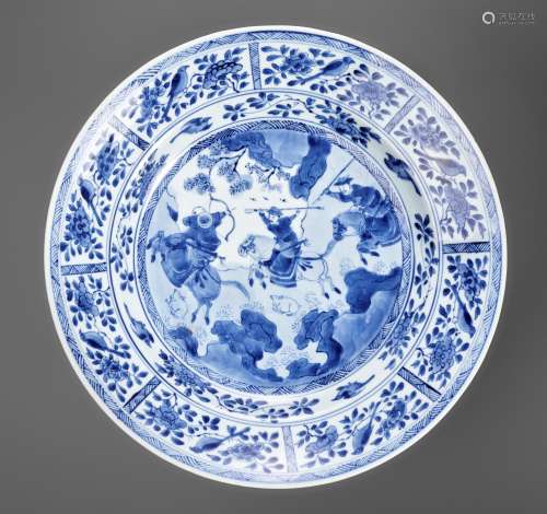 A LARGE BLUE AND WHITE 'HUNTING SCENE' DISH, KANGX...