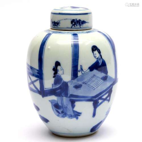 A blue and white lidded canister with figures