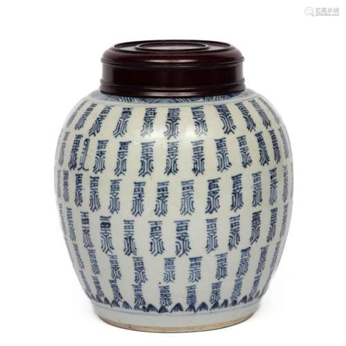 A blue and white jar with wooden lid