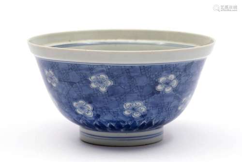 A blue and white prunus with cracked ice pattern bowl