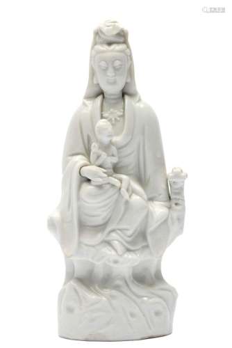 A blanc-de-chine figure of a Guanyin with child