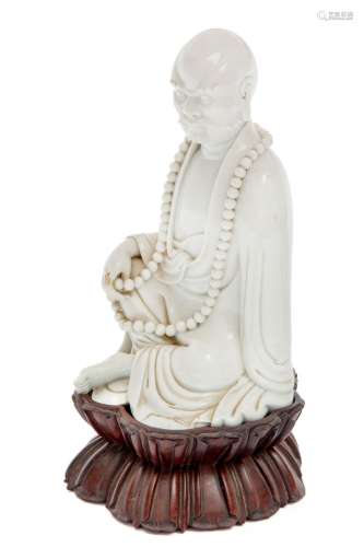 A blanc-de-chine figure of a seated Luohan
