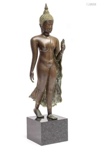 A bronze walking Buddha