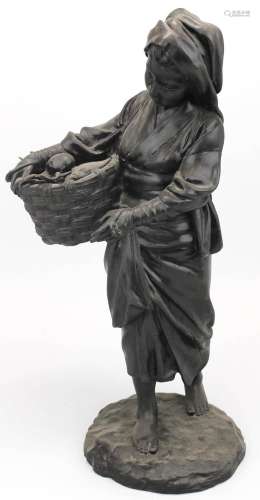 A Japanese Tokyo School bronze of a woman carrying a fish ba...