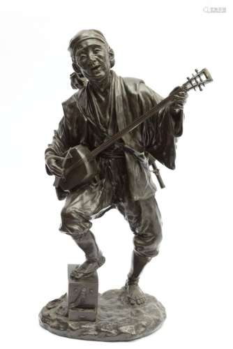 A Japanese Tokyo School bronze figure of a man playing a sha...