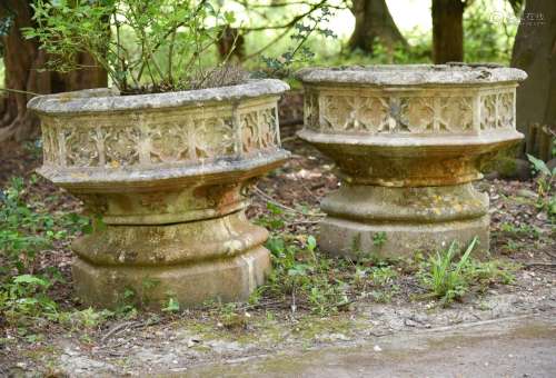 A PAIR OF STONE COMPOSITION GARDEN PLANTERS, IN GOTHIC TASTE