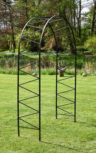 A BLACK PAINTED IRON WROUGHT IRON GARDEN ARCH