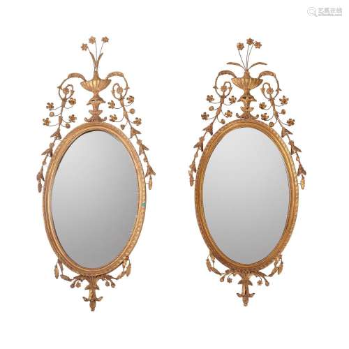 A PAIR OF GILT GESSO OVAL WALL MIRRORS