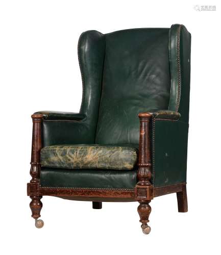 A MAHOGANY AND GREEN LEATHER UPHOLSTERED WING ARMCHAIR