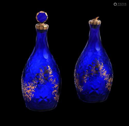 A PAIR OF BLUE GLASS DECANTERS AND STOPPERS