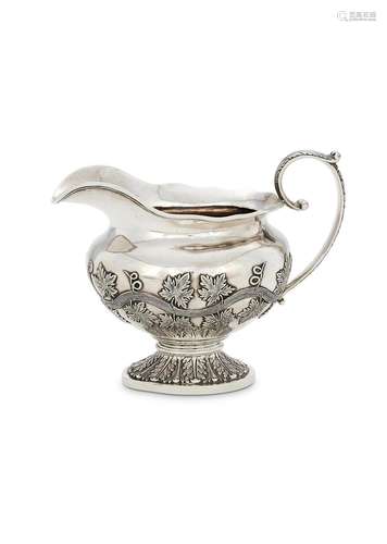 AN INDIAN COLONIAL SILVER OVAL PEDESTAL MILK JUG