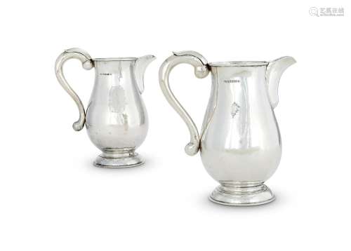 A PAIR OF SILVER HAMMERED BALUSTER JUGS