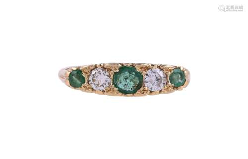 AN EMERALD AND DIAMOND FIVE STONE RING