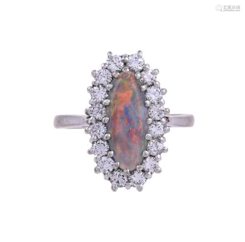 A BLACK OPAL AND DIAMOND CLUSTER RING, LONDON 1975