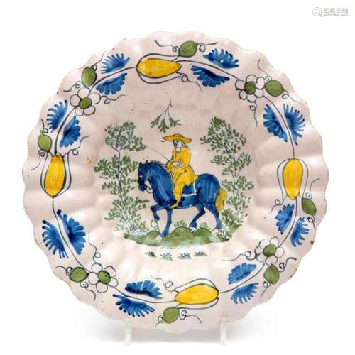 A Delft pottery charger with a horseman