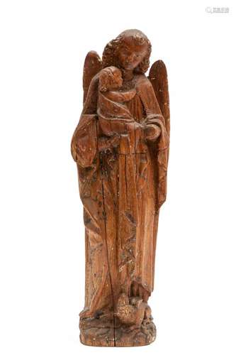 A carved oak figure of a winged angel holding a child