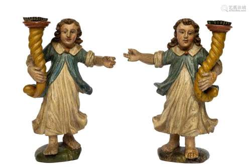 A pair of carved and polychrome painted wooden angels with t...