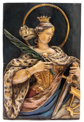 A carved and polychrome painted wooden relief of Saint Cathe...