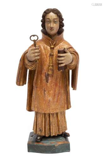 A carved and polychrome painted wooden figure of Saint Peter