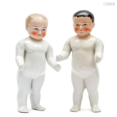 A pair of  Frozen Charlie  porcelain bathing dolls