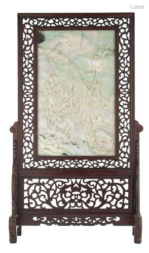 A Chinese carved emerald jade plaque, fitted to a hardwood t...