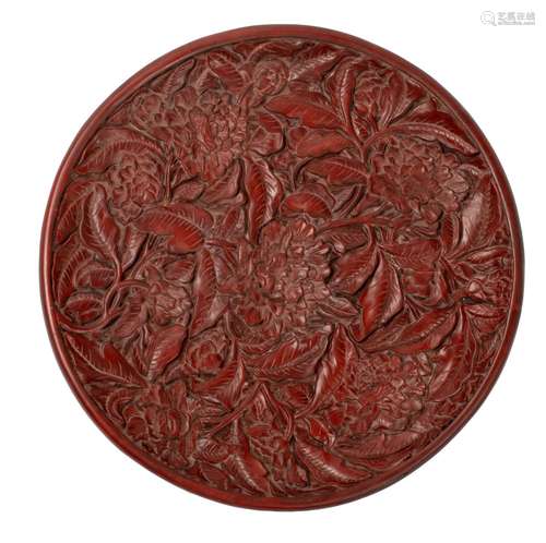 A Chinese carved cinnabar lacquer charger, the back with a p...