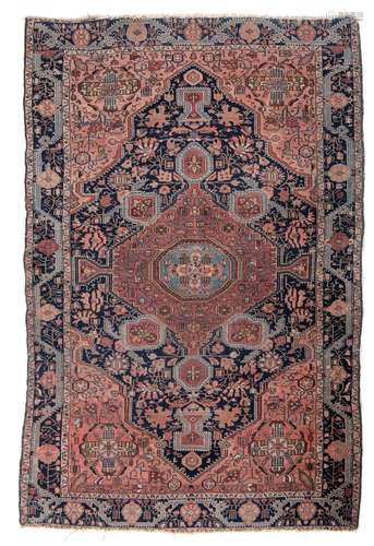 An antique Persian Sarouk rug, decorated with geometric moti...