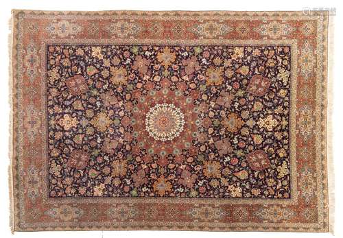 An Oriental woollen rug with a central medaillon, floral dec...