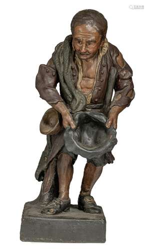 A polychrome painted terracotta sculpture of a beggar, 19thC...