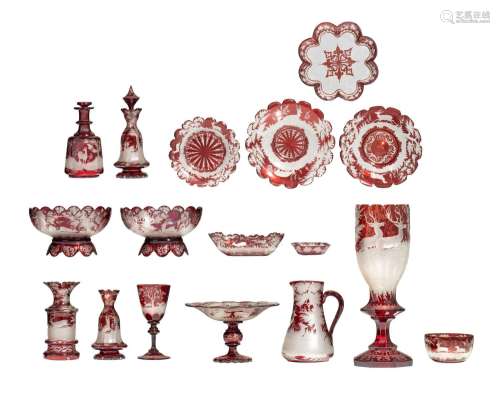 A large collection of red Bohemian glass items, with etched ...