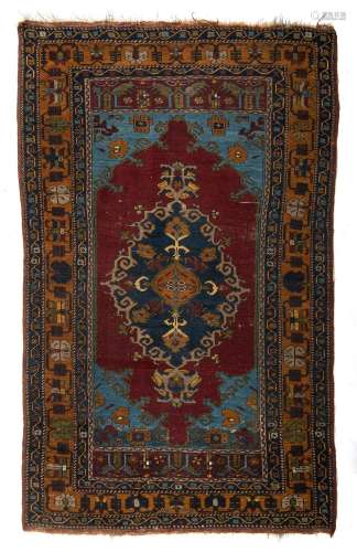 An Oriental woollen carpet, decorated with geometric motifs ...