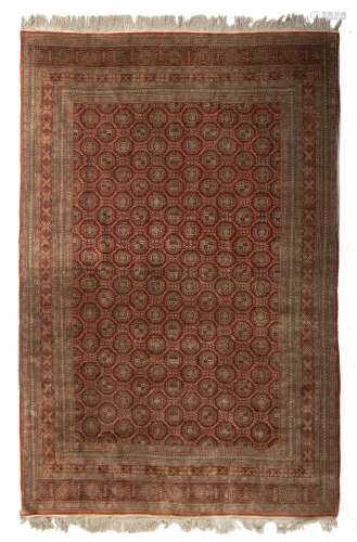 An Oriental silk carpet, decorated with geometric motifs, 18...