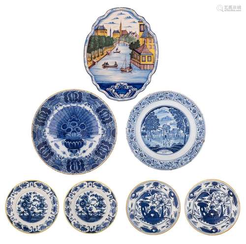 A collection of Delft dishes, chargers and a plaque, 18th/19...