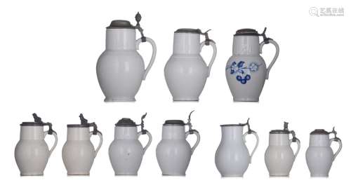 A decorative collection of 10 pewter lidded white pottery ja...