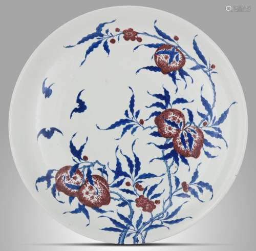 A Chinese copper red and underglaze blue 'Peaches' plate, wi...