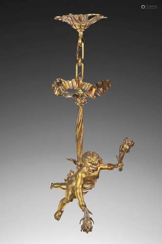 Lustre en bronze ciselé et doré figurant un putto retenu par...