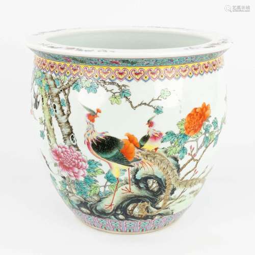 A Chinese cache pot made of porcelain and decorated with pho...