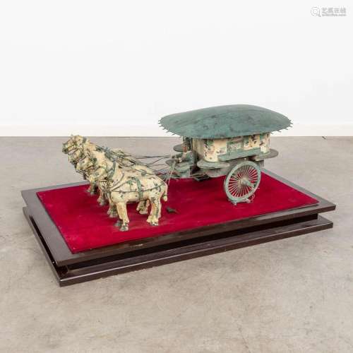 A Chinese horse-drawn carriage, made of bronze and metal, af...