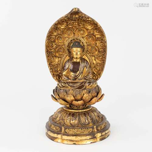A wood sculptured Buddha, sitting on a lotus flower. (H:28 c...