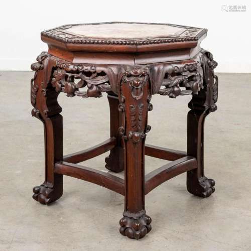 An Oriental octagonal stand, hardwood and finished with a ma...