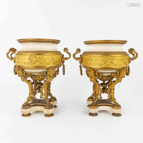 A pair of urns, made of gilt bronze and white Carrara marble...