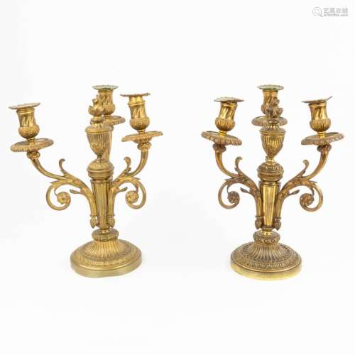 A pair of candelabra made of gilt bronze in Louis XVI style....
