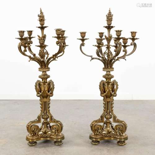 A pair of large neoclassical candelabra made of polished bro...