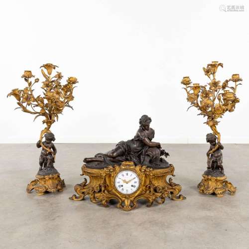A three-piece mantle garniture clock and candelabra, Louis X...