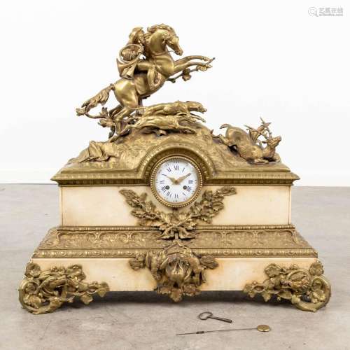 A large mantle clock with a hunting scne, made of bronze an...