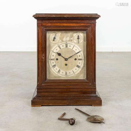 An antique English table clock with 3 gongs. Silver-plated d...